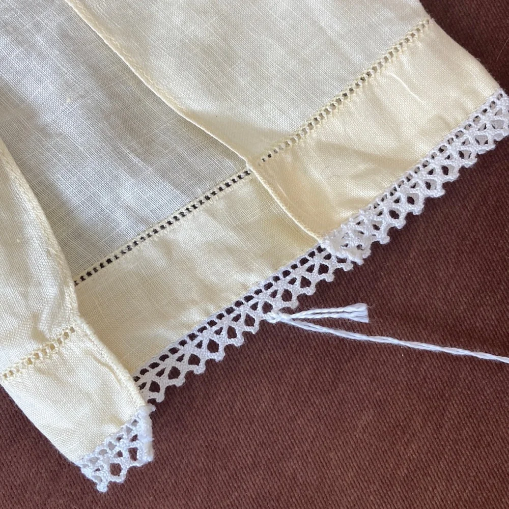 One fine linen embroidered tea towel. A muted butter yellow Vintage 1960s